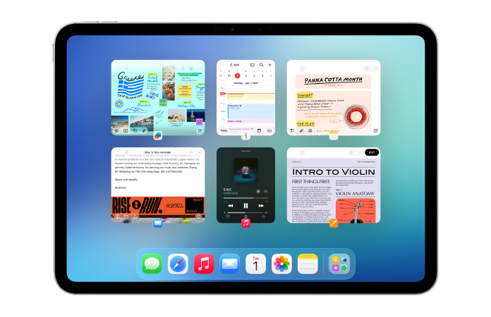 iPad, orientasi lanskap, menampilkan enam jendela yang terbuka dalam dua baris, termasuk aplikasi Kalender, aplikasi Catatan, Apple Music, dan Safari