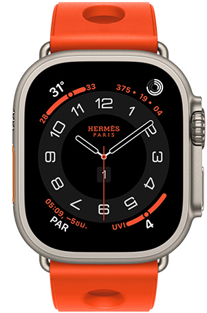 Apple Watch Hermès Ultra 3, Circulaire analog watch face, (hour, minute and second hands, complications: Weather, activity rings, Paris time and UV Index), titanium case, natural color, right side exterior, Digital Crown, raised side button, paired with Scub'H Diving band, orange néon color (bright orange), molded rubber material, circular cutouts centered