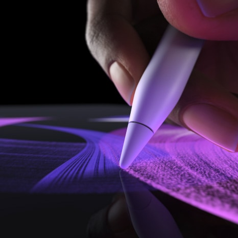 Person uses Apple Pencil Pro in Procreate, creating a vibrant brush line.