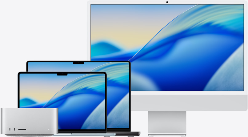 De gauche à droite, le fond d’écran macOS Tahoe sur plusieurs modèles Mac : Mac Studio, MacBook Air 13 pouces bleu ciel, MacBook Pro 14 pouces noir sidéral et iMac 24 pouces argent